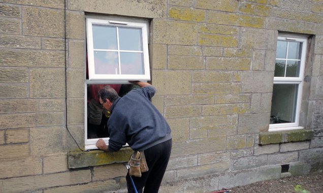 Man installing a window