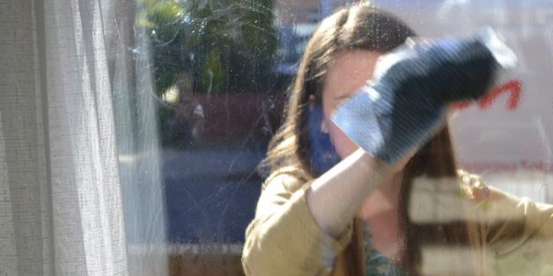 Woman cleaning window