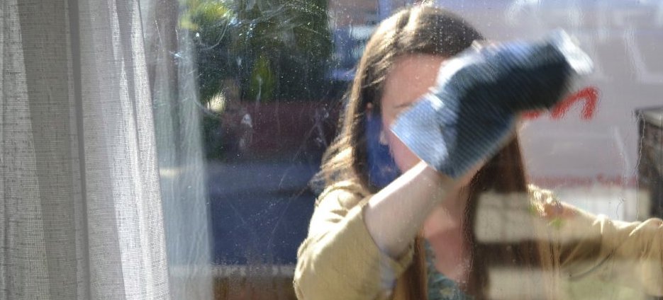 Woman cleaning window