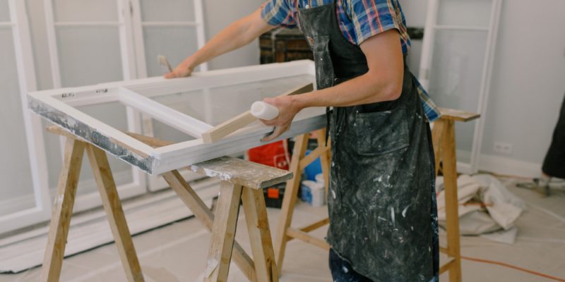 man preparing a window for window replacement