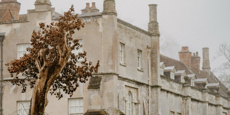 old stone historic building with sash windows and chimneys