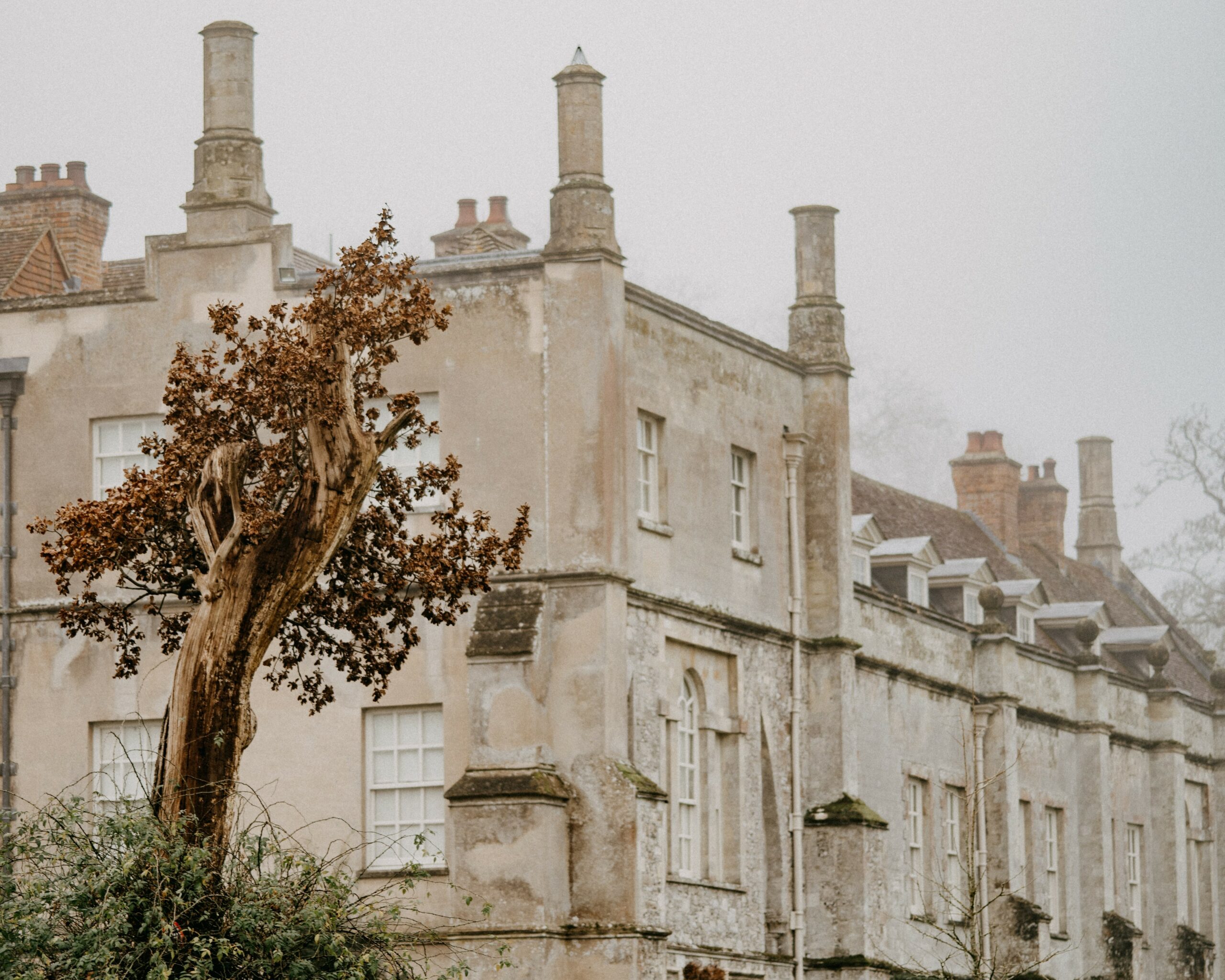 old stone historic building with sash windows and chimneys